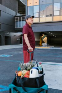 Man with a wagon full of groceries.