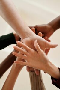 Photo of stacked hands.